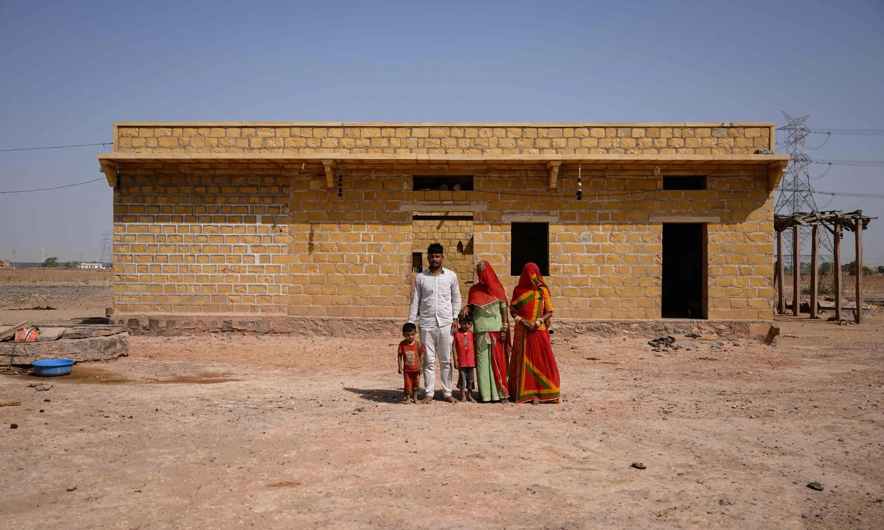 This photograph taken on May 29, 2026 shows herdsman Sawai Singh Bhati (2L) posing for a family portrait in 42 degrees Celsius temperatures, at their house in Sanwata village on the outskirts of Rajasthan’s Jaisalmer city. — AFP