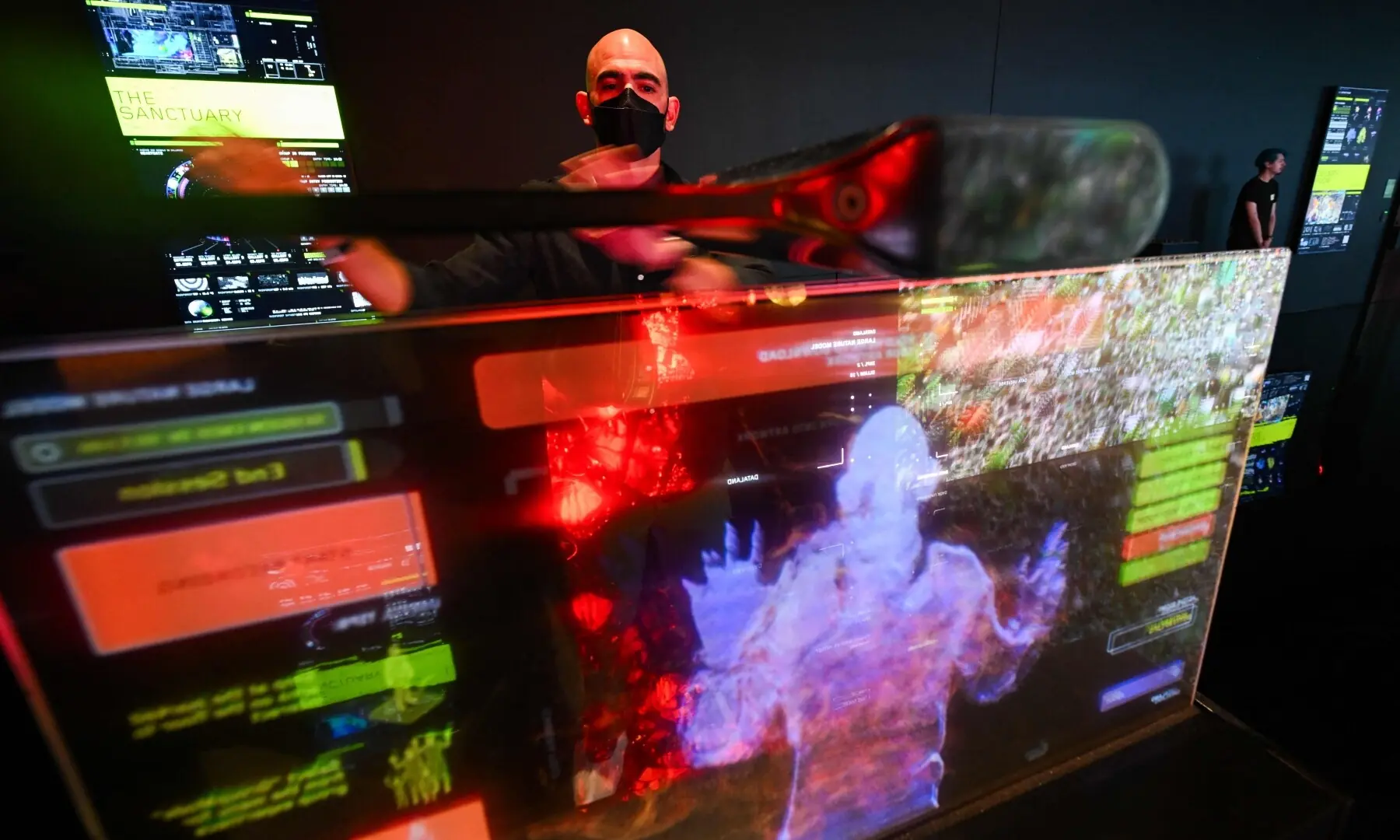 A guest gestures with a screen and cameras to interact with Immersive visualisations from the inaugural exhibition Machine Dreams: Rainforest are projected at Dataland, the Museum of AI Arts, in Los Angeles, California on June 9, 2026. — AFP