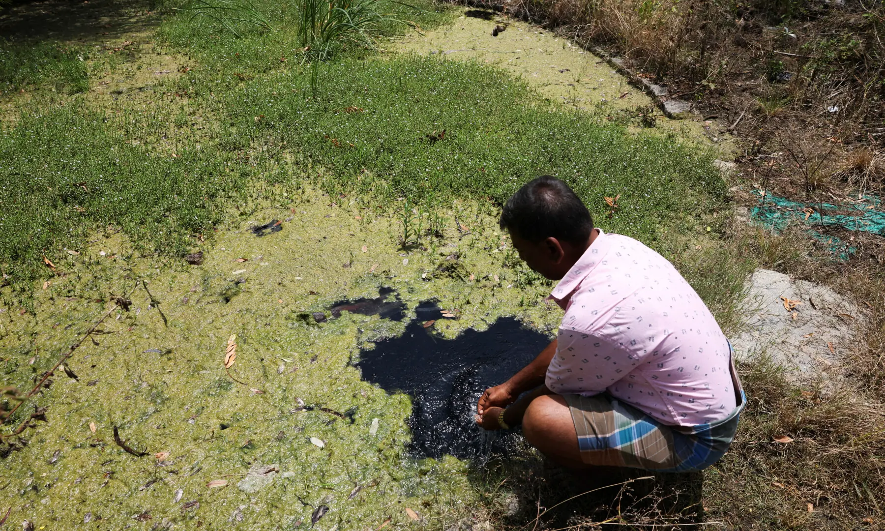 A farmer washes his hands in his open well, near the Tata Electronics’ components factory for Apple’s iPhone in Hosur, Tamil Nadu, India on June 15, 2026. — Reuters