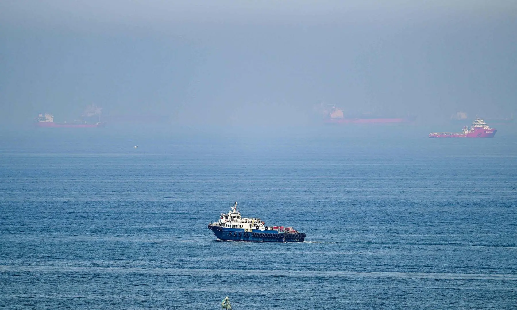 Cargoships are pictured off cost of the Khor Fakkan Container Terminal, the only natural deep-sea port in the region and one of the major container ports in Sharjah Emirate, along the Gulf of Oman on June 19, 2026. &mdash; AFP