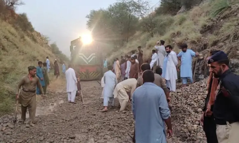 Emergency maintenance teams work on clearing debris from the railway track in Attock's Jand tehsil on June 19. &mdash; photo via author