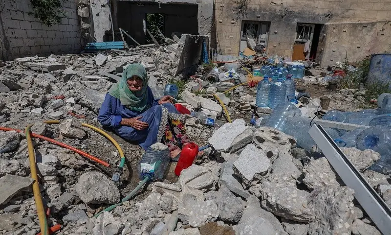 Khadija Amara, whom local residents said had not left her home, fills a jerrycan with water as she sits among the rubble of a house, which was damaged by an Israeli strike, in Qlaileh in the Tyre district, southern Lebanon. — Reuters Khadija Amara, whom local residents said had not left her home, fills a jerrycan with water as she sits among the rubble of a house, which was damaged by an Israeli strike, in Qlaileh in the Tyre district, southern Lebanon. — Reuters