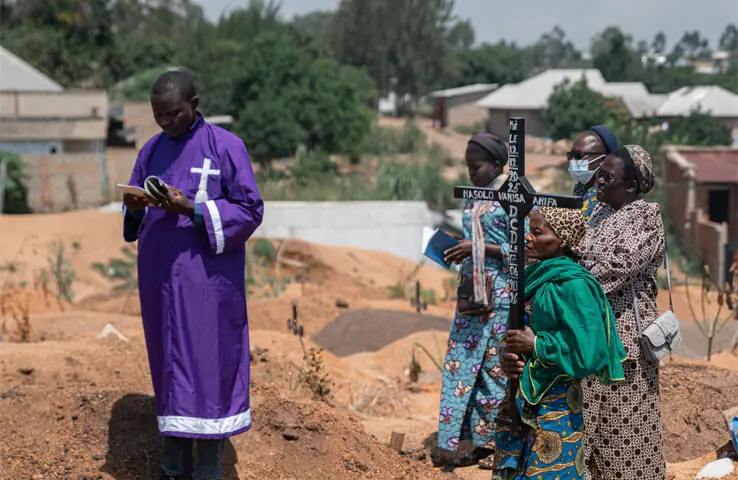 A priest conducts a blessing ceremony at Mbiyo cemetery for a fourth child who died from Ebola virus disease at an orphanage in Bunia.—AFP A priest conducts a blessing ceremony at Mbiyo cemetery for a fourth child who died from Ebola virus disease at an orphanage in Bunia.—AFP