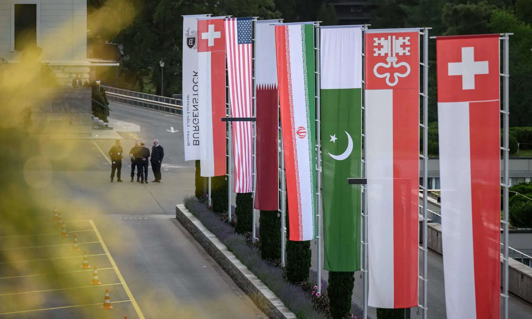  Flags of Switzerland, United States, Qatar, Pakistan and local Swiss canton of Nidwalden are photographed at the Burgenstock luxury hotel complex overlooking Lake Lucerne, Switzerland, on June 21, 2026. &mdash; AFP 