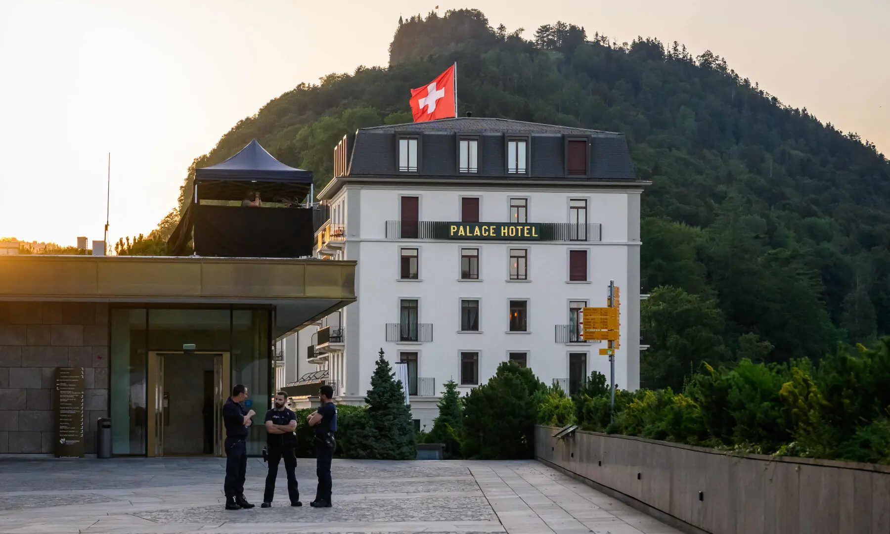  Police officers stand next to a building at the Burgenstock luxury hotel complex overlooking Lake Lucerne, Switzerland, on June 21, 2026. &mdash; AFP 