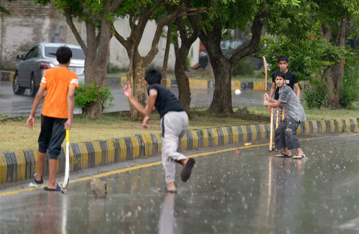 Youngsters play cricket on a road in Islamabad’s G-6 sector during rain on Sunday. The other picture shows a rainbow that broke out over the federal capital after the downpour. — Photos by Mohammad Asim Youngsters play cricket on a road in Islamabad’s G-6 sector during rain on Sunday. The other picture shows a rainbow that broke out over the federal capital after the downpour. — Photos by Mohammad Asim