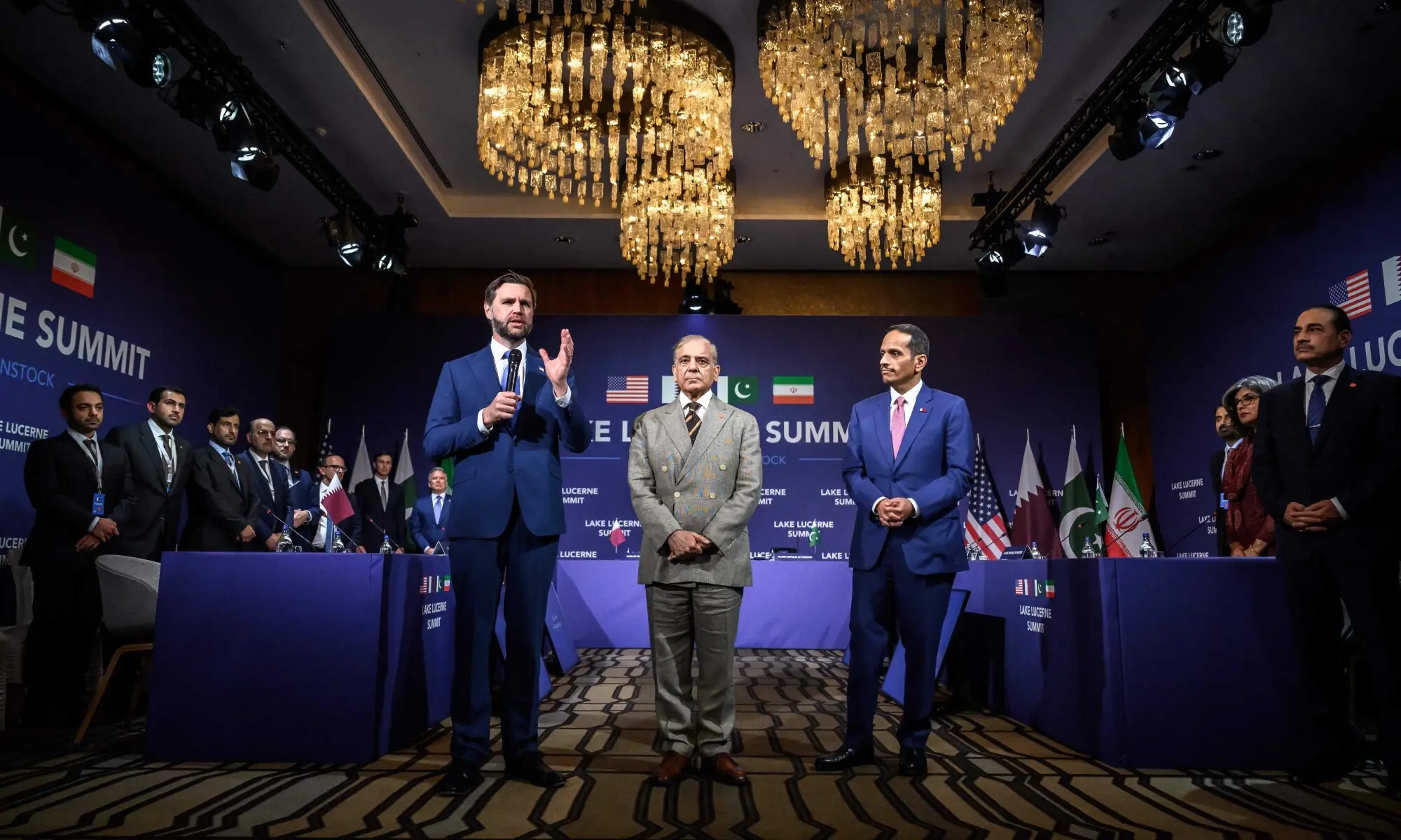 US Vice President JD Vance (L) speaks next to Pakistan's Prime Minister Shehbaz Sharif (C) and Qatar's Prime Minister and Minister for Foreign Affairs Sheikh Mohammed bin Abdulrahman bin Jassim Al-Thani at the start of a quadrilateral meeting between the United States, Iran, Pakistan and Qatar at the Burgenstock luxury hotel complex overlooking Lake Lucerne, Switzerland, on June 21, 2026, as part of high-level talks aimed at advancing a deal to end the Middle East conflict. A new round of negotiations over US Vice President JD Vance (L) speaks next to Pakistan's Prime Minister Shehbaz Sharif (C) and Qatar's Prime Minister and Minister for Foreign Affairs Sheikh Mohammed bin Abdulrahman bin Jassim Al-Thani at the start of a quadrilateral meeting between the United States, Iran, Pakistan and Qatar at the Burgenstock luxury hotel complex overlooking Lake Lucerne, Switzerland, on June 21, 2026, as part of high-level talks aimed at advancing a deal to end the Middle East conflict. A new round of negotiations over