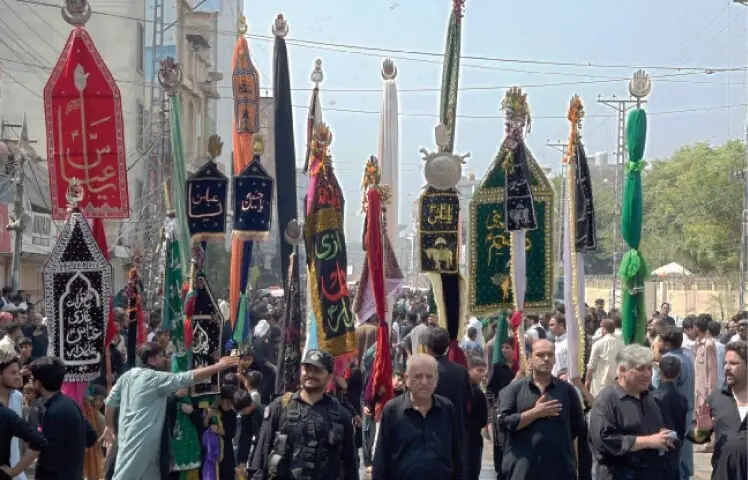 Mourners hold alam as they take part in 9th Muharram procession in Peshawar Cantt on Monday. — White Star/File Mourners hold alam as they take part in 9th Muharram procession in Peshawar Cantt on Monday. — White Star/File