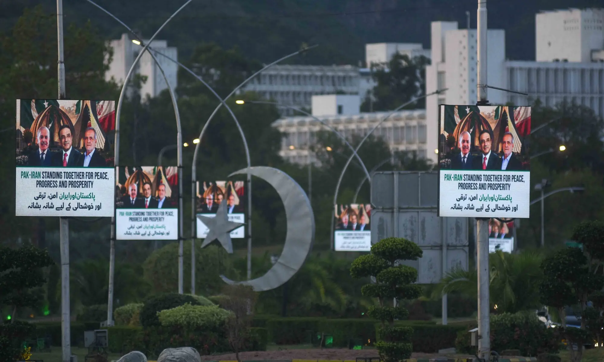 Screens display images of President Asif Ali Zardari, Prime Minister Shehbaz Sharif, and Iran's President Masoud Pezeshkian ahead of his visit, in Islamabad, Pakistan, June 22, 2026. &mdash; Reuters