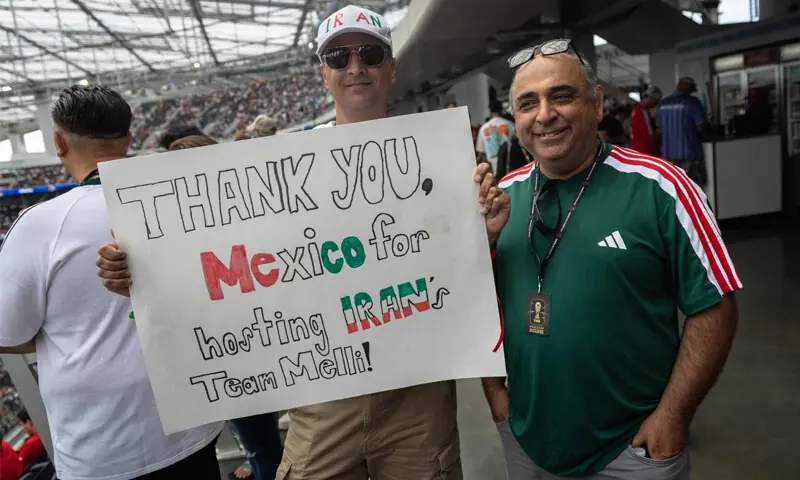LOS ANGELES (California): Iranian fans show a sign that reads “Thank you, Mexico for hosting Iran’s team Melli” ahead of their Group ‘G’ match against Belgium.—AFP LOS ANGELES (California): Iranian fans show a sign that reads “Thank you, Mexico for hosting Iran’s team Melli” ahead of their Group ‘G’ match against Belgium.—AFP