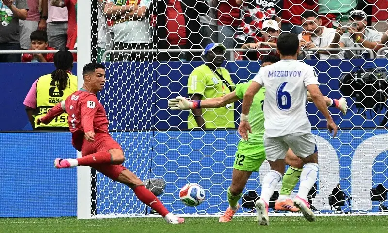 Portugal's Cristiano Ronaldo (L) shoots to score against Uzbekistan during their 2026 World Cup Group 'K' match at the Houston Stadium in Houston on June 23, 2026. &mdash;AFP