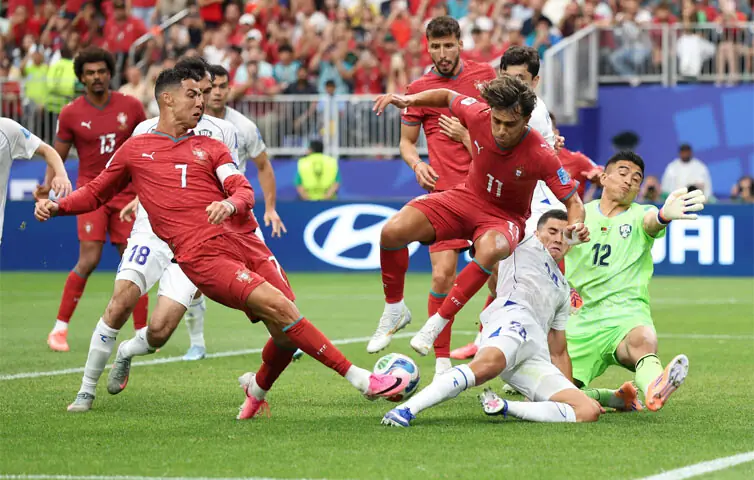 HOUSTON: Cristiano Ronaldo of Portugal shoots which resulted in an own goal scored by Abdukodir Khusanov of Uzbekistan during their Group ‘K’ match at the Houston Stadium on Tuesday.—AFP HOUSTON: Cristiano Ronaldo of Portugal shoots which resulted in an own goal scored by Abdukodir Khusanov of Uzbekistan during their Group ‘K’ match at the Houston Stadium on Tuesday.—AFP