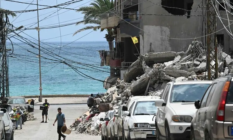 A man walks on the rubbles as he looks for items in a building hit in earlier Israeli military strikes on a neighbourhood in the southern Lebanese coastal city of Tyre on June 23, 2026. &mdash;Reuters