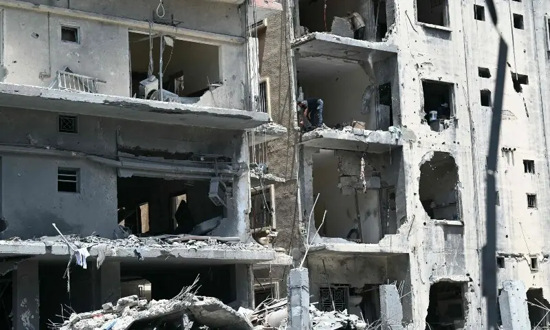 Construction workers removes debris from a damaged building at the site of an earlier Israeli military strike on a neighbourhood in the southern Lebanese coastal city of Tyre on June 23, 2026. &mdash;Reuters