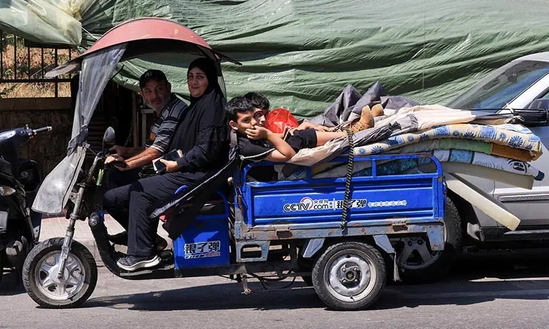 A family loads their belongings into a small cart as they prepare to return home following an interim deal between the US and Iran, after living in temporary tents in Beirut, Lebanon on June 24, 2026. &mdash; Reuters
