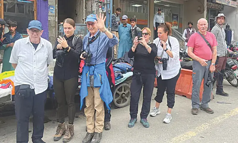 In this file photo foreign tourists explore New Bazaar in Skardu.&mdash;Dawn/File