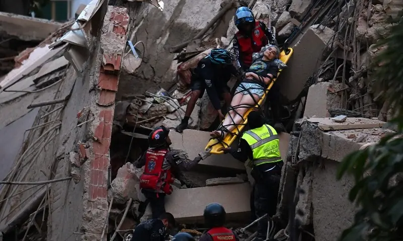  Rescue workers carry a person on a stretcher out of a collapsed building following an earthquake in Caracas on June 24, 2026. &mdash;AFP 