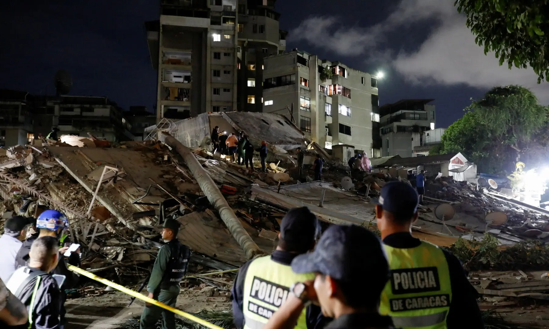  Police officers and rescuers work at the site of damaged buildings in the aftermath of an earthquake, in Caracas, Venezuela, June 24, 2026. &mdash;Reuters 