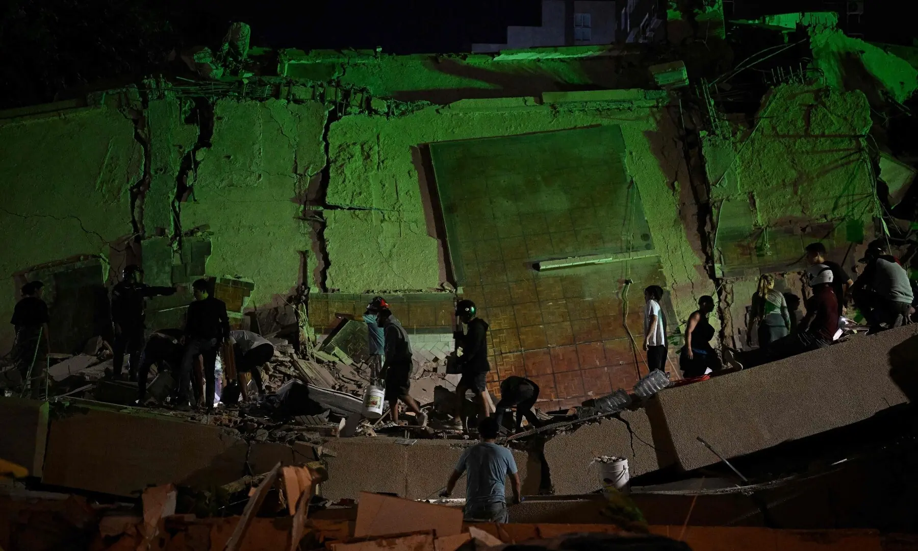 Rescue workers search through the rubble of a collapsed building in the Altamira neighbourhood following an earthquake in Caracas on June 24, 2026. &mdash;AFP