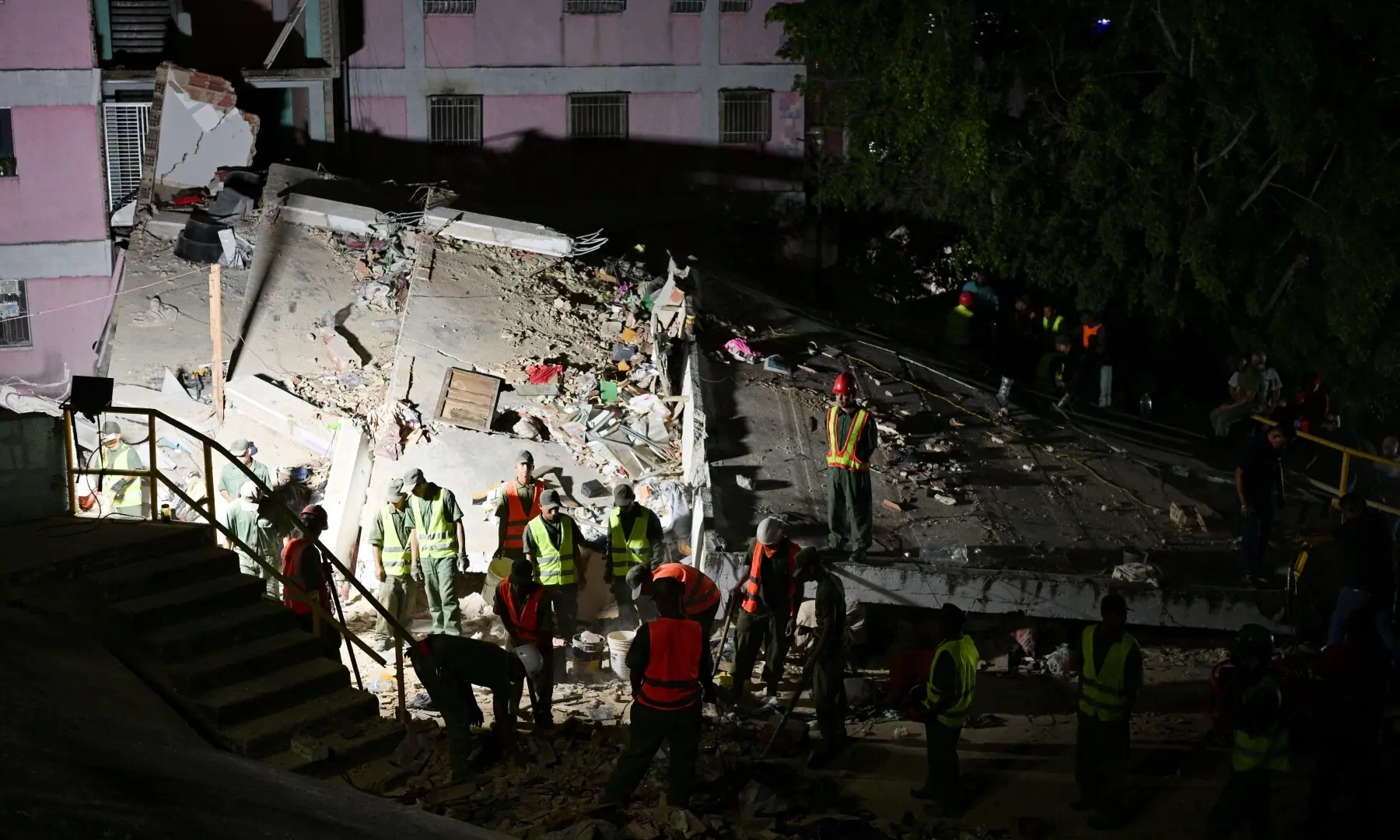  Police officers and rescuers work at the site of damaged buildings in the aftermath of an earthquake, in Caracas, Venezuela, June 24, 2026. &mdash;Reuters 