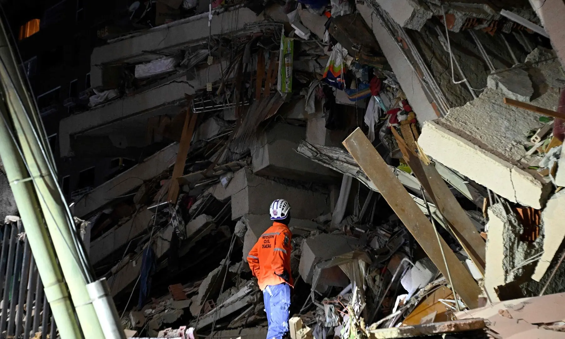  A rescuer looks at the rubble of a collapsed building following an earthquake in Caracas on June 24, 2026. &mdash;AFP 