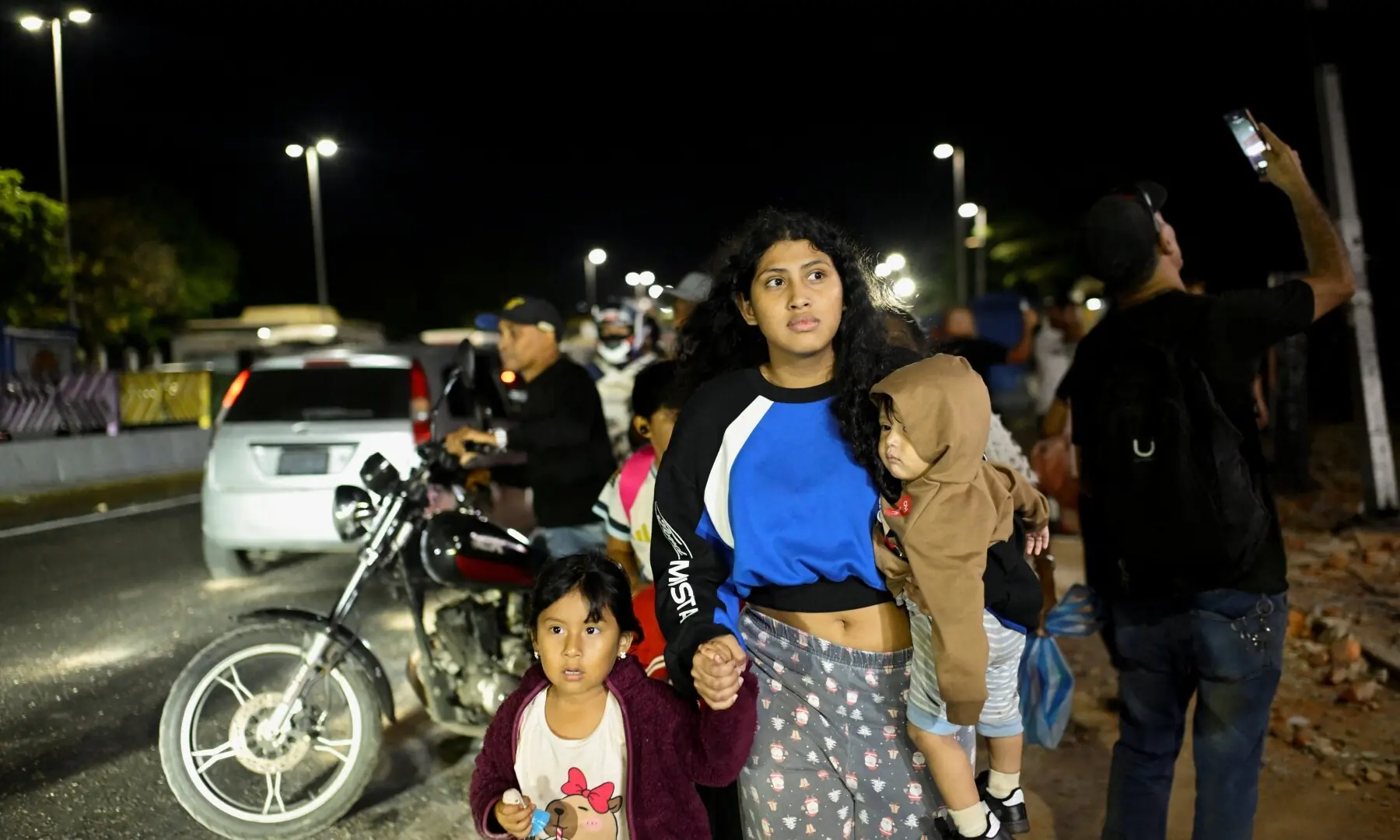  A woman walks with kids after an earthquake, in Caracas, Venezuela, June 24, 2026. &mdash;Reuters 