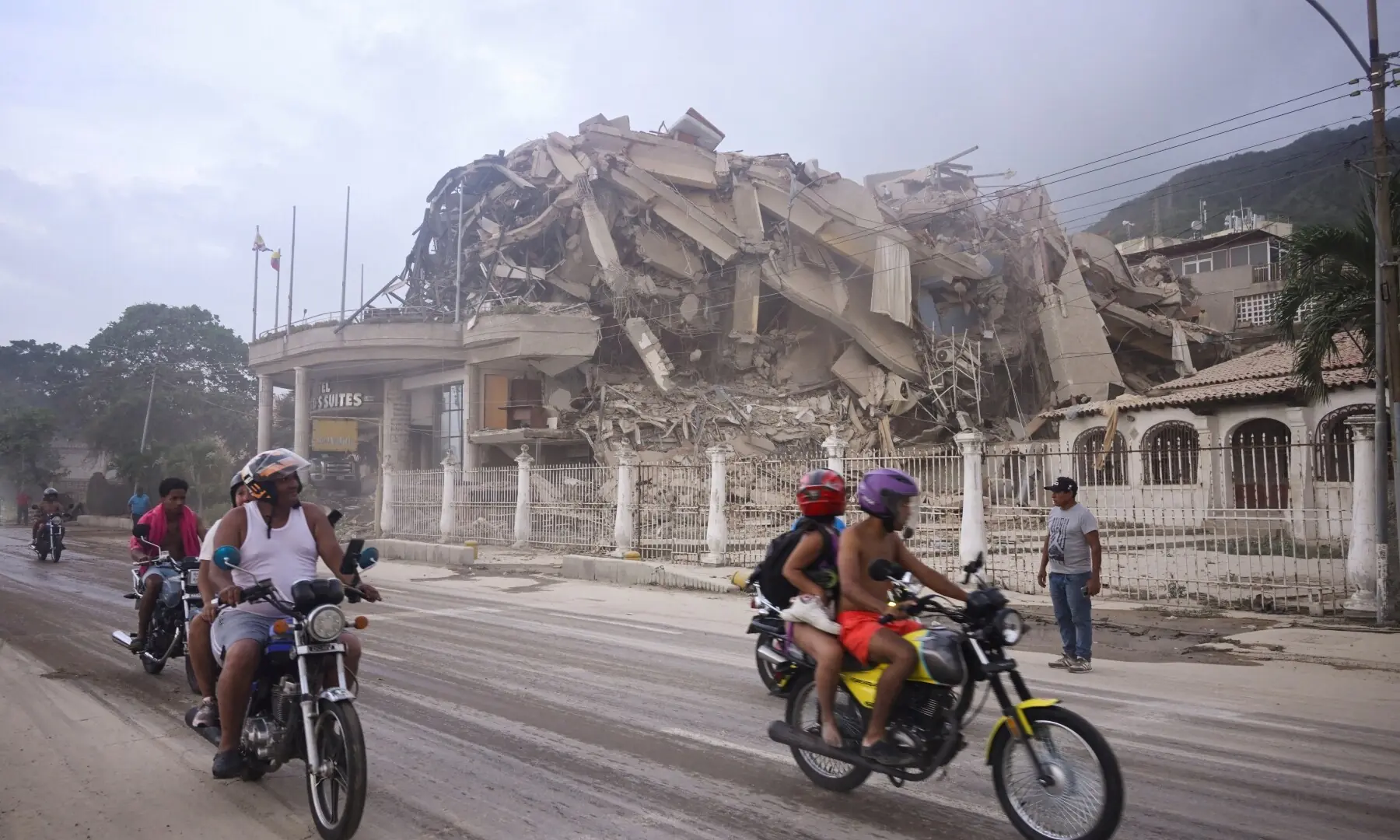 People ride past a collapsed building after an earthquake, in La Guaira, Venezuela, June 24, 2026. &mdash;Reuters