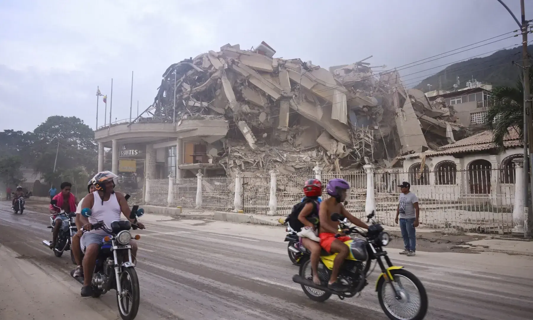 People ride past a collapsed building after an earthquake, in La Guaira, Venezuela, June 24, 2026. &mdash; Reuters