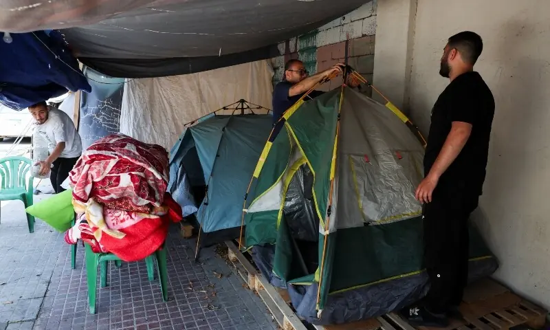  Men pack and organize their belongings as they prepare to return home following an interim deal between the US and Iran, after living in temporary tents in Beirut, Lebanon, June 24, 2026. &mdash;Reuters 
