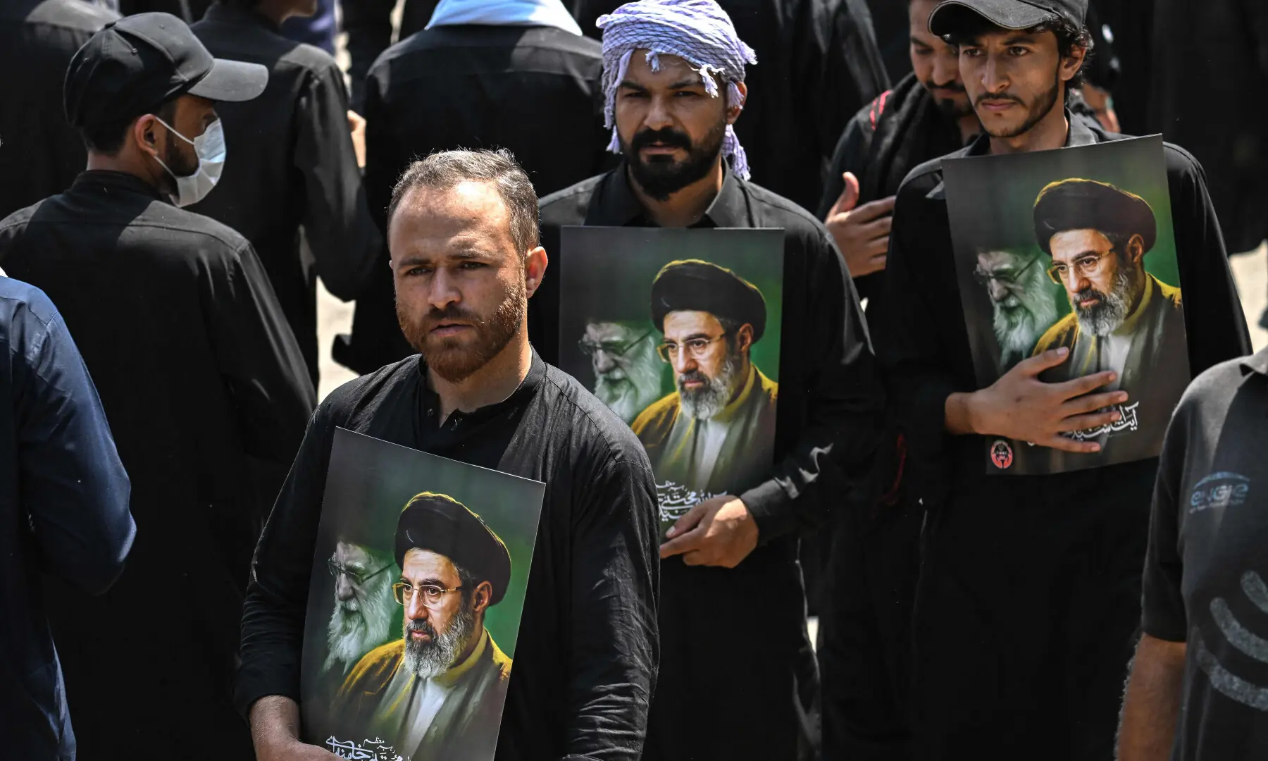 Muslims hold portraits of Iran&rsquo;s supreme leader Mojtaba Khamenei (R) and late supreme leader Ayatollah Ali Khamenei as they take part in a procession on the ninth day of Muharram in Islamabad on June 25, 2026. &mdash; AFP