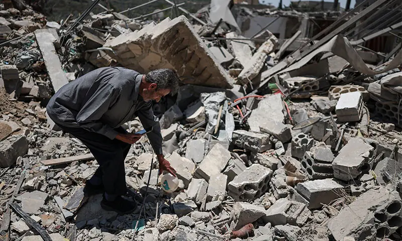 A DISPLACED Lebanese man shows his house, destroyed by an Israeli air strike, to his grandson, during a video call after returning to Maaroub, a municipality in Tyre district, southern Lebanon.&mdash;Reuters