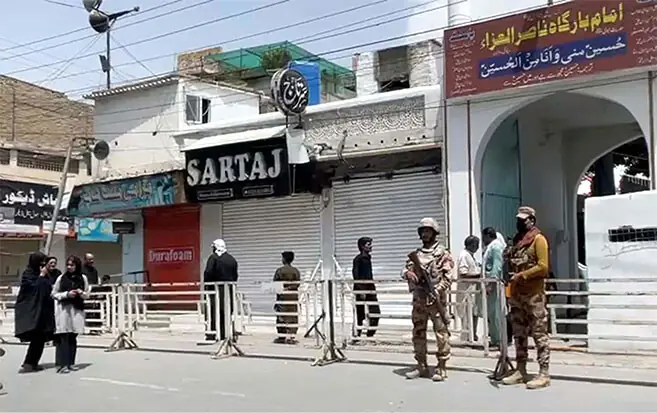 Security personnel stand guard outside an Imambargah in Quetta as mourners perform religious rites on 9th Muharram.&mdash;PPI