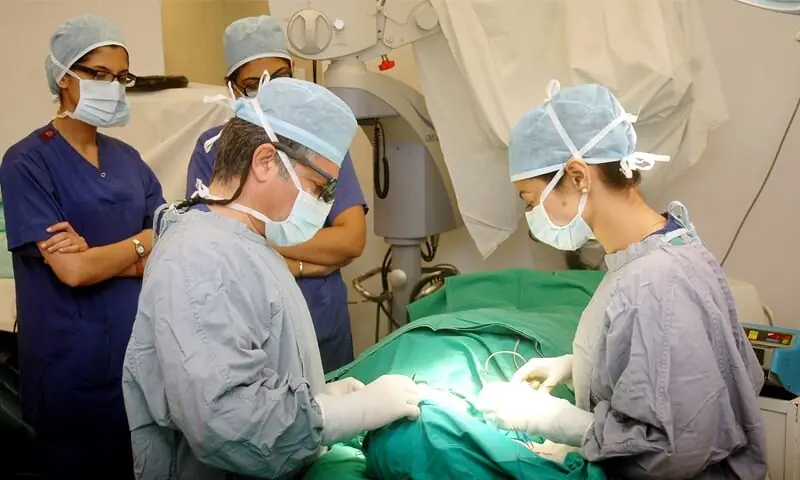 Doctors performs surgery in this fikle photo. &mdash; White Star/File