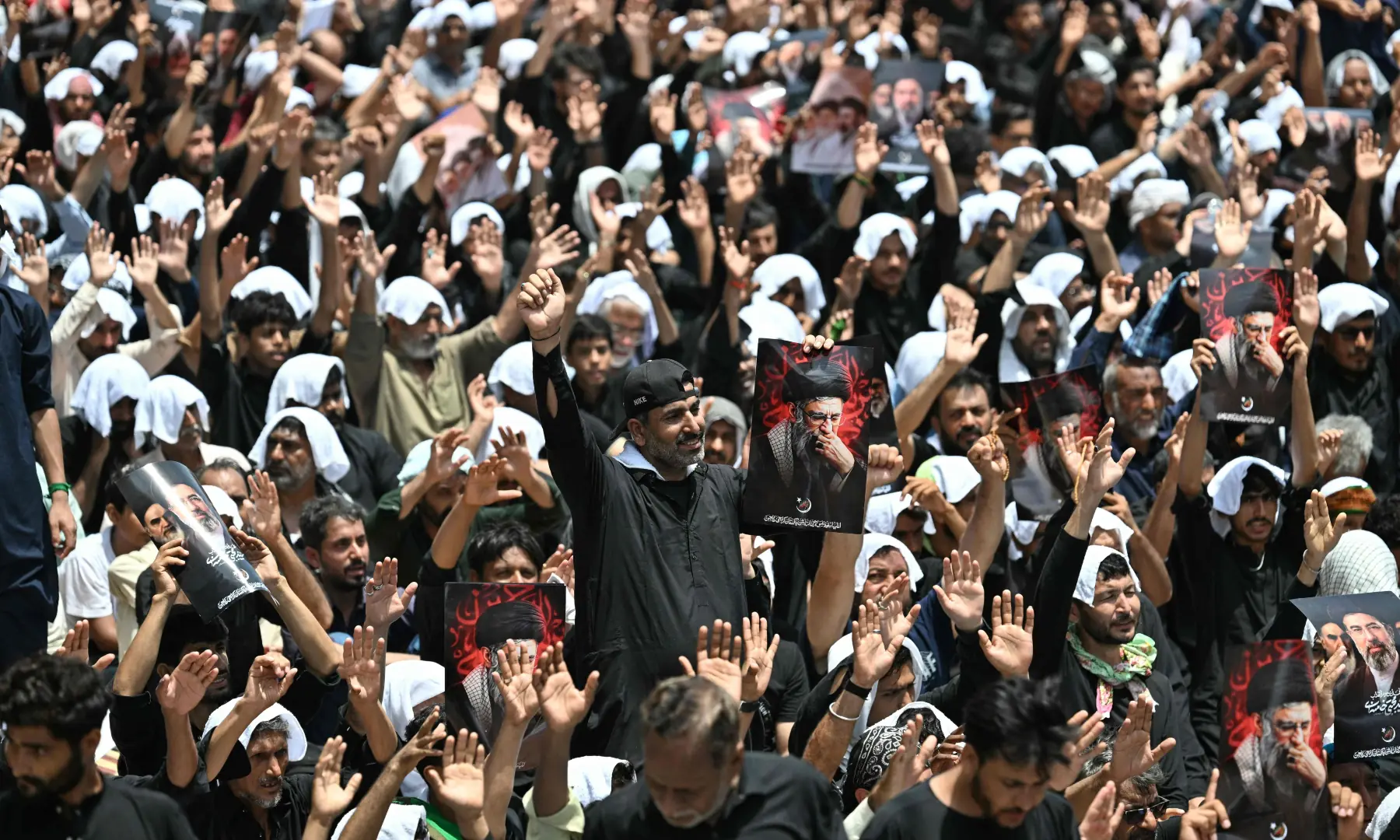Mourners holding portraits of Iran&rsquo;s late supreme leader Ayatollah Ali Khamenei take part in a procession to mark Ashura on the tenth day of Muharram in Karachi on June 26, 2026. &mdash; AFP