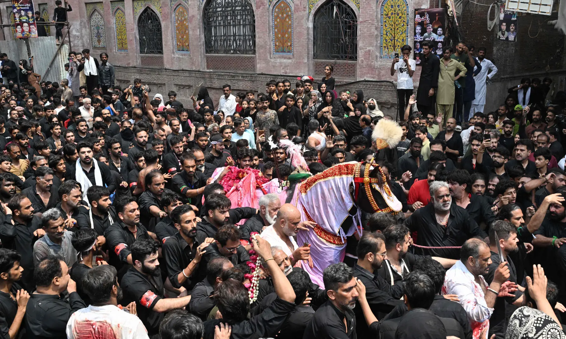 Mourners take part in a religious procession marking Ashura on the tenth day of Muharram in Lahore on June 26, 2026. &mdash; AFP