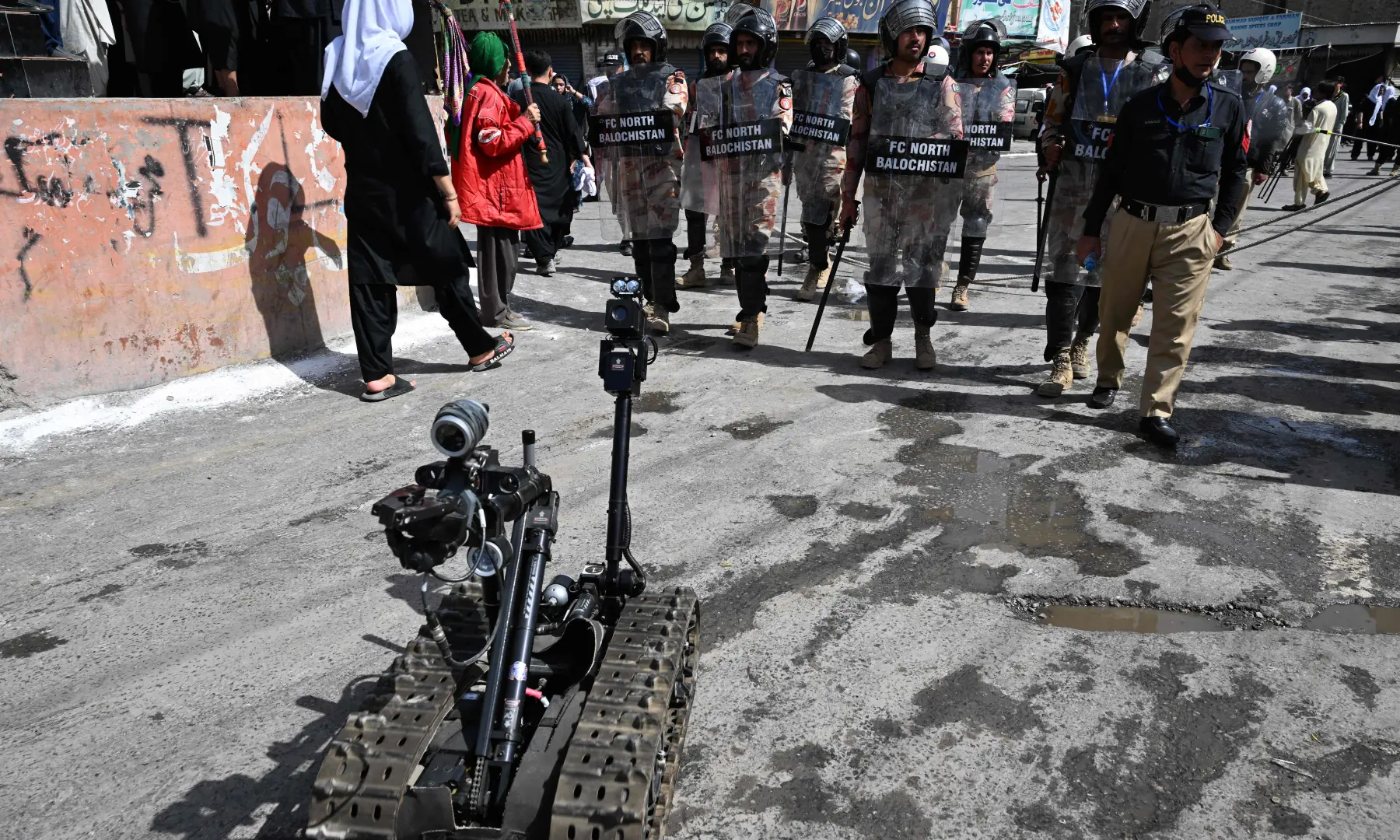 Security personnel patrol along a street during the Muharram procession on the tenth day of Ashura in Quetta on June 26, 2026. &mdash; AFP