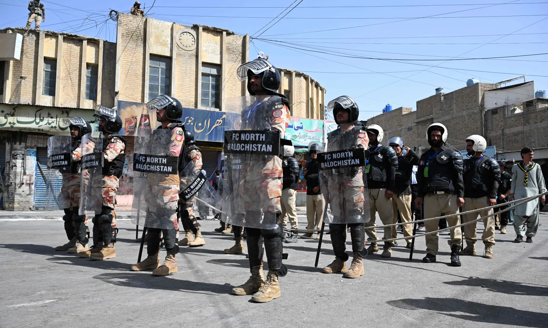 Security personnel stand guard during the Muharram procession on the tenth day of Ashura in Quetta on June 26, 2026. &mdash; AFP
