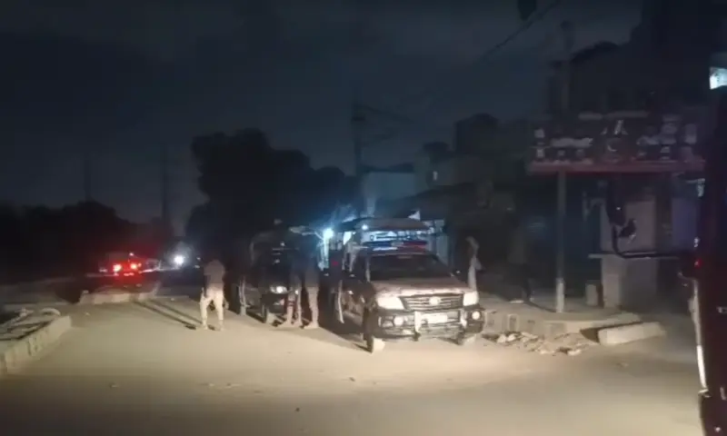 Rangers personnel stand guard at a road in Karachi after firing and an explosion was reported. &mdash; screengrab from video via Rescue1122