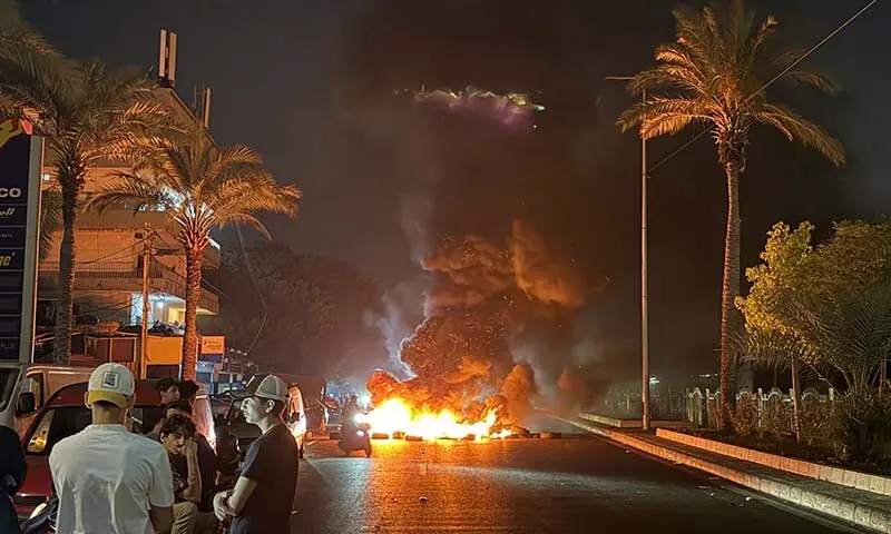 Hezbollah supporters block the old airport road in the southern suburbs of Beirut, Lebanon with burning tires to protest against the trilateral agreement that was signed between the US, Israel and Lebanon on June 27, 2026. &mdash; AFP