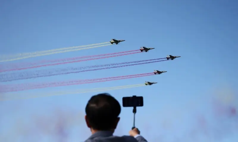 A man films South Korean Air Force FA-50 fighter jets during Seoul International Aerospace & Defence Exhibition (ADEX) in Seongnam, South Korea, October 17, 2025. &mdash; Reuters/File