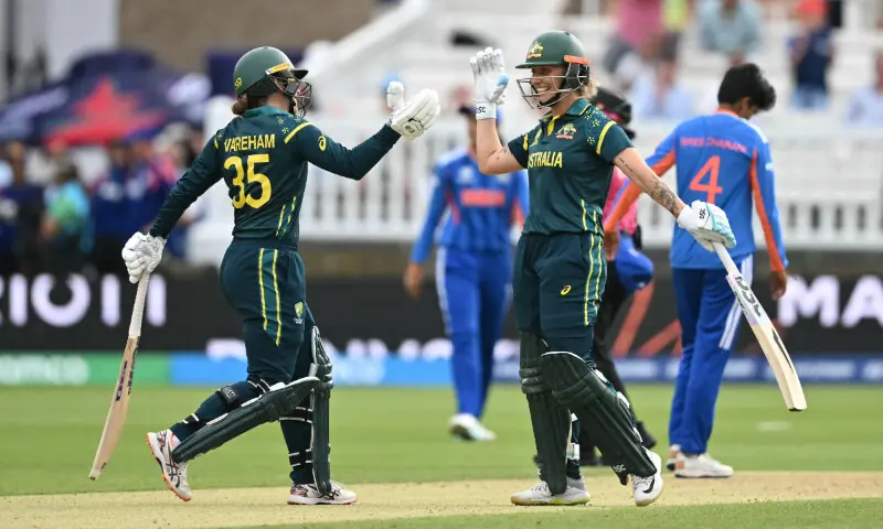 Australia's Georgia Wareham (L) and Australia's Ashleigh Gardner (R) celebrate after beating India in the ICC Women's T20 cricket world cup 2026 game between Australia and India, at Lord's in London on June 28, 2026. &mdash; AFP