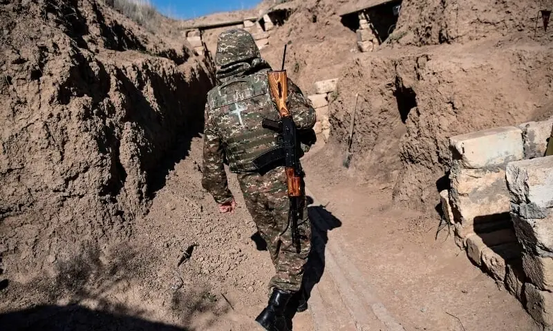 In this file photo taken on Oct 25, 2020, an Armenian soldier walks as troops hold positions on the front line during the fighting between Armenian and Azerbaijani forces over the breakaway region of Nagorno-Karabakh. &mdash; AFP/File