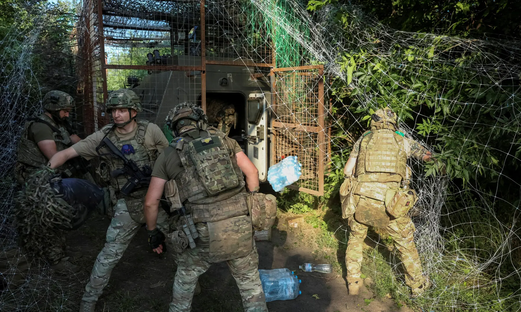 Ukrainian servicemen from the special patrol police unit Hyzhak (Predator) unload a military vehicle as they arrive for the combat mission, near the frontline town of Kostiantynivka in the Donetsk region, Ukraine on June 24, 2026. &mdash; Reuters