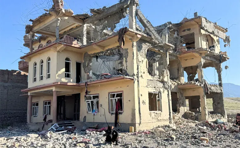 A man sits outside a building that was destroyed in a Pakistani strike in Samkani district, Afghanistan&rsquo;s Paktia province.&mdash;Reuters