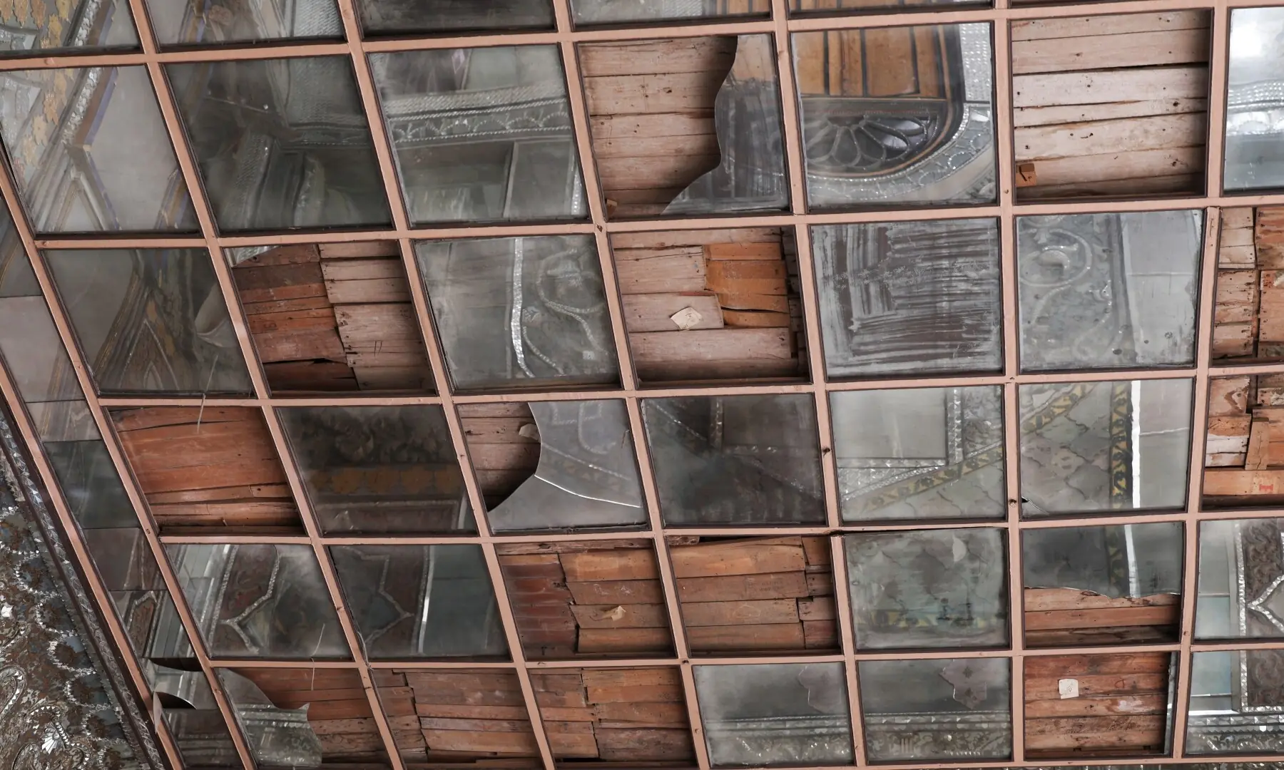 Broken glass panels on the ceiling inside the Hall of Mirrors (Talar-e Ayne) at Golestan Palace, a Unesco World Heritage site, amid the US-Israeli conflict with Iran, in Tehran, Iran, on March 21, 2026. &mdash; Reuters