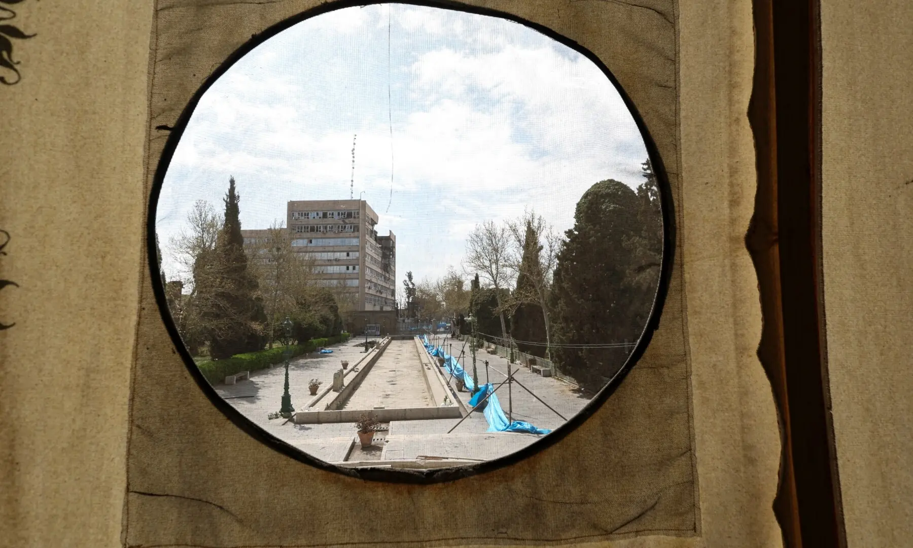 A damaged building is seen through a circular from the Golestan Palace, amid the US-Israeli conflict with Iran in Tehran, Iran, on March 21, 2026. &mdash; Reuters