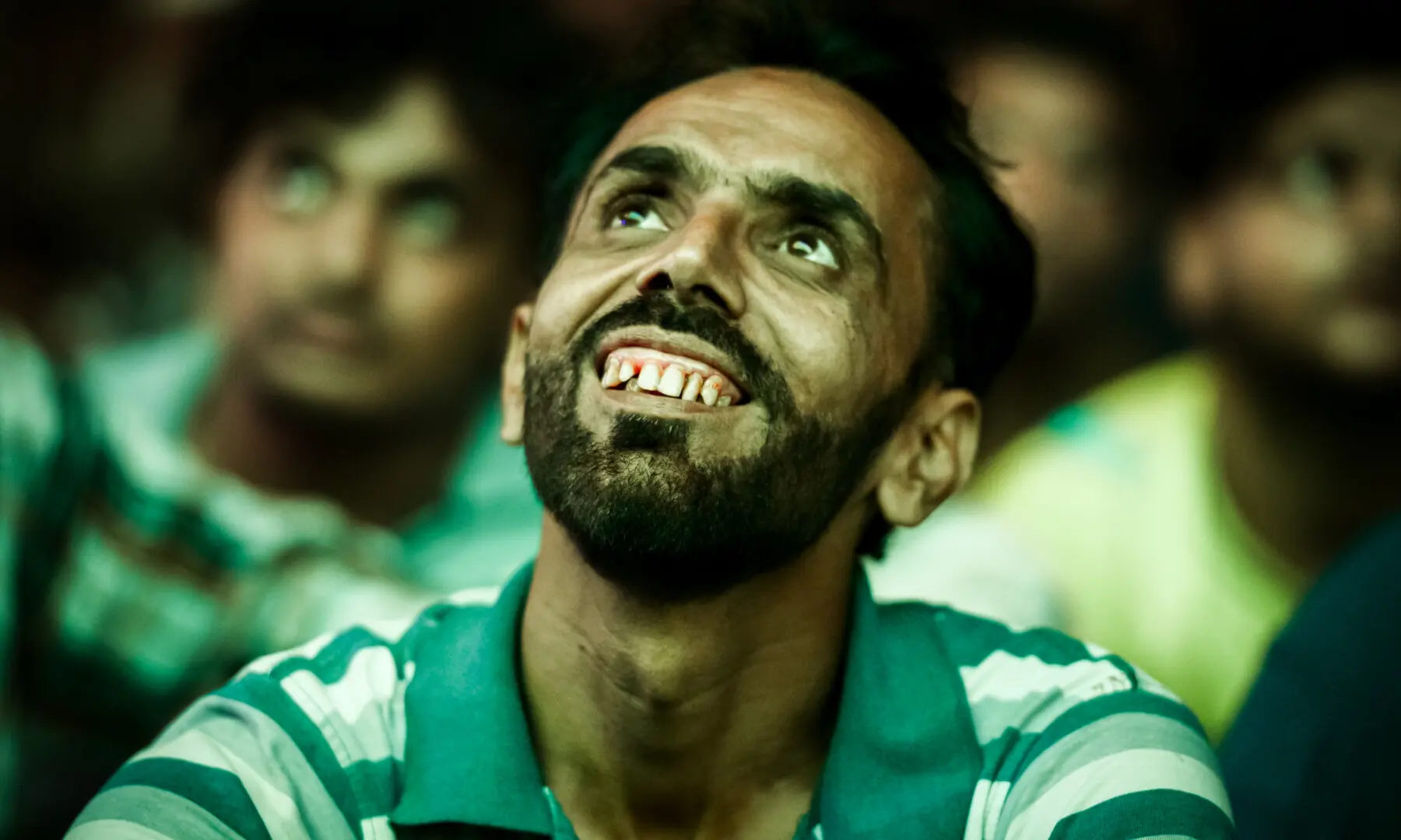A football fan smiles during a screening of the FIFA World Cup match between Brazil and Japan at Lyari International Football Stadium in Karachi on June 29, 2026. &mdash; Tahir Jamal