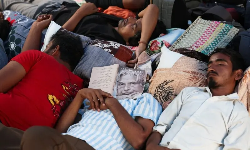Supporters of the Cockroach Janta Party (CJP) sleep on a carpet during a sit-in protest called by CJP demanding the resignation of Indian Education Minister Dharmendra Pradhan, at Jantar Mantar in New Delhi, India, June 30. &mdash; Reuters