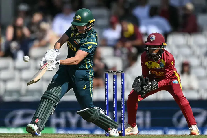 LONDON: Australian opener Beth Mooney hits a four as West Indies wicket-keeper Shemaine Campbelle looks on during the Women&rsquo;s T20 World Cup semi-final at The Oval on Tuesday.&mdash;AFP