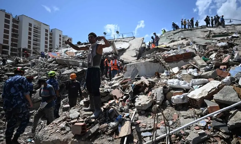 A relative of victims gestures while shouting as rescue workers and volunteers operate at the site of a collapsed building in Caraballeda, La Guaira State, Venezuela on July 1. — AFP A relative of victims gestures while shouting as rescue workers and volunteers operate at the site of a collapsed building in Caraballeda, La Guaira State, Venezuela on July 1. — AFP